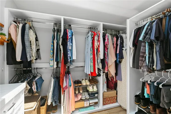 a view of walk in closet with clothes