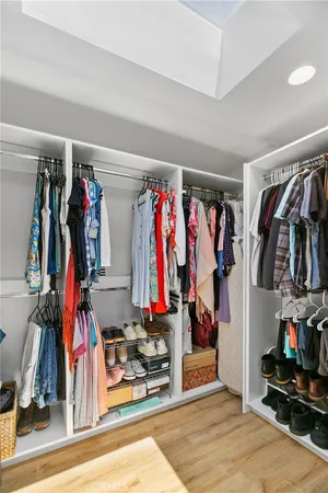 a view of walk in closet with clothes