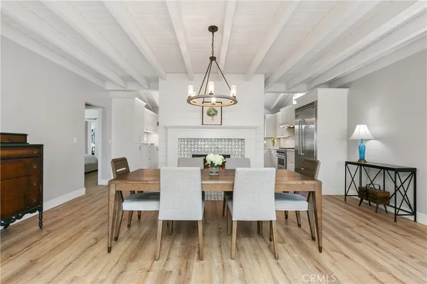 a view of a dining room with furniture wooden floor and chandelier