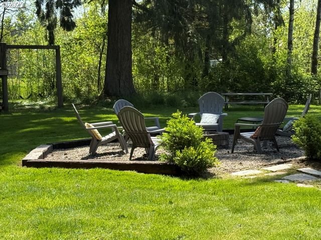 5203 Northeast 246th Street Ridgefield, WA 98642 - Photo 5 of 7 a view of a chair and table in backyard of the house