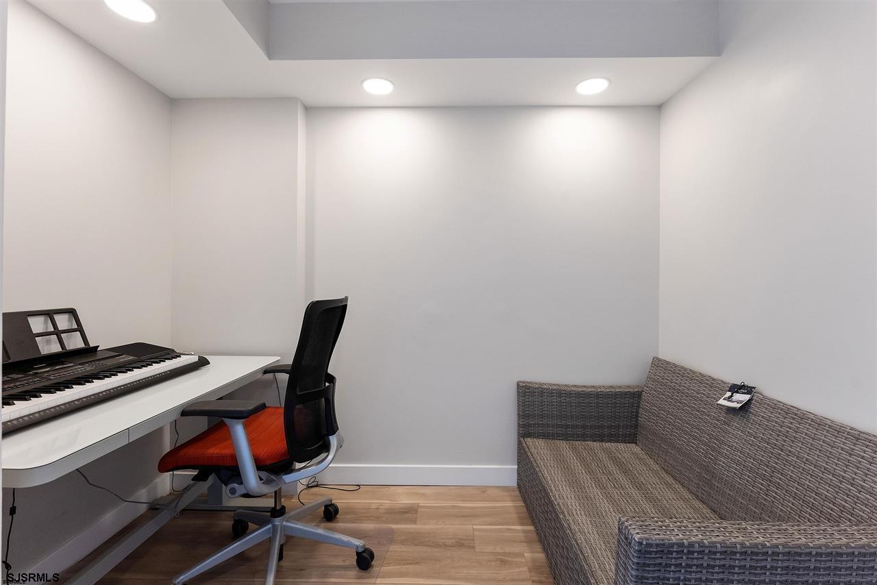 9100 Beach 304, Unit 304 Margate City, NJ 08402 - Photo 13 of 25 a view of a workspace with furniture and wooden floor