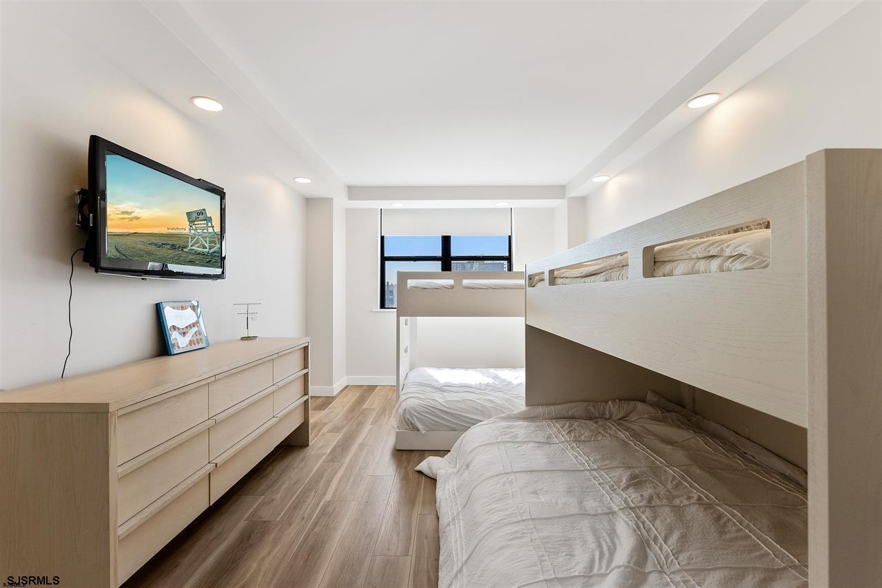 9100 Beach 304, Unit 304 Margate City, NJ 08402 - Photo 15 of 25 a bedroom with furniture and a flat screen tv