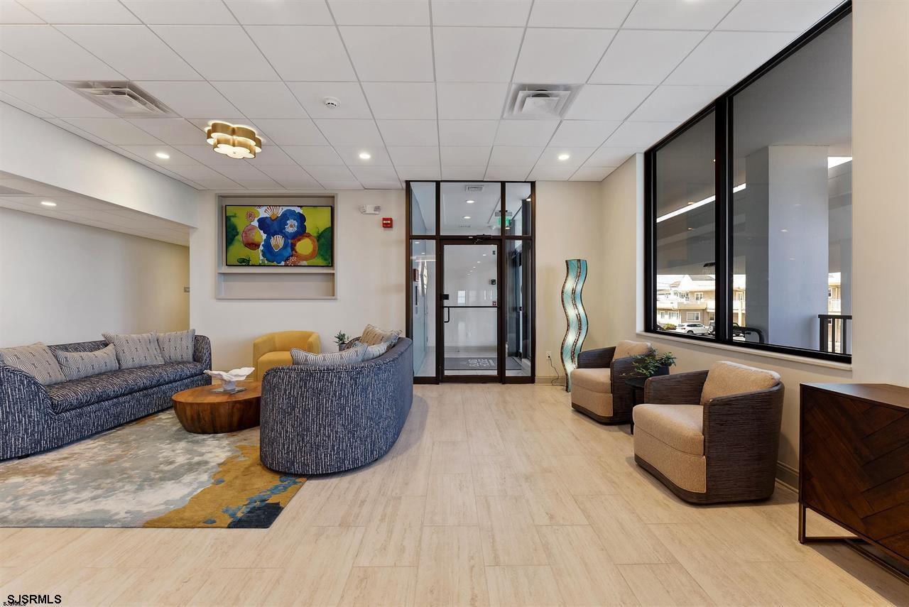 9100 Beach 304, Unit 304 Margate City, NJ 08402 - Photo 20 of 25 a living room with furniture and a flat screen tv