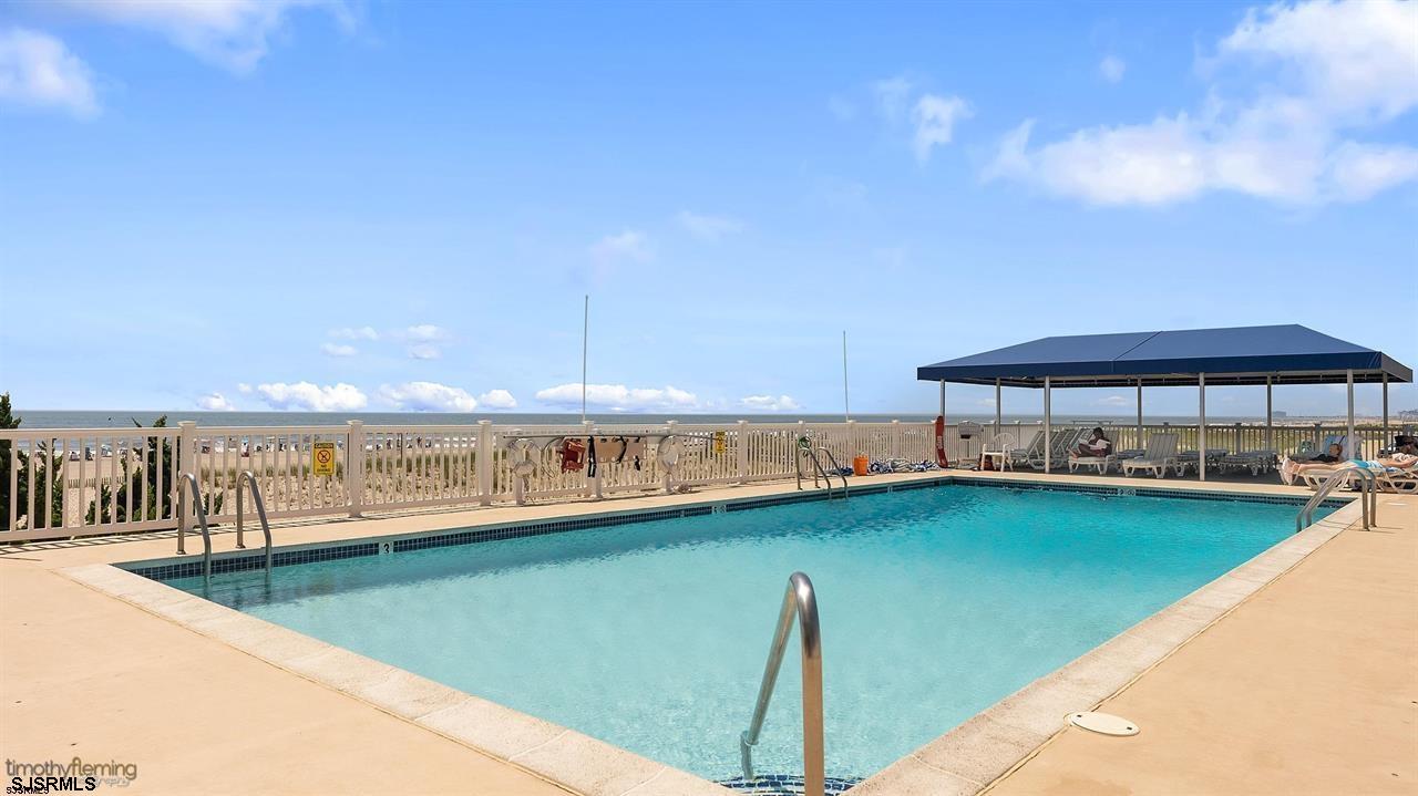9100 Beach 304, Unit 304 Margate City, NJ 08402 - Photo 25 of 25 a view of a swimming pool from a balcony
