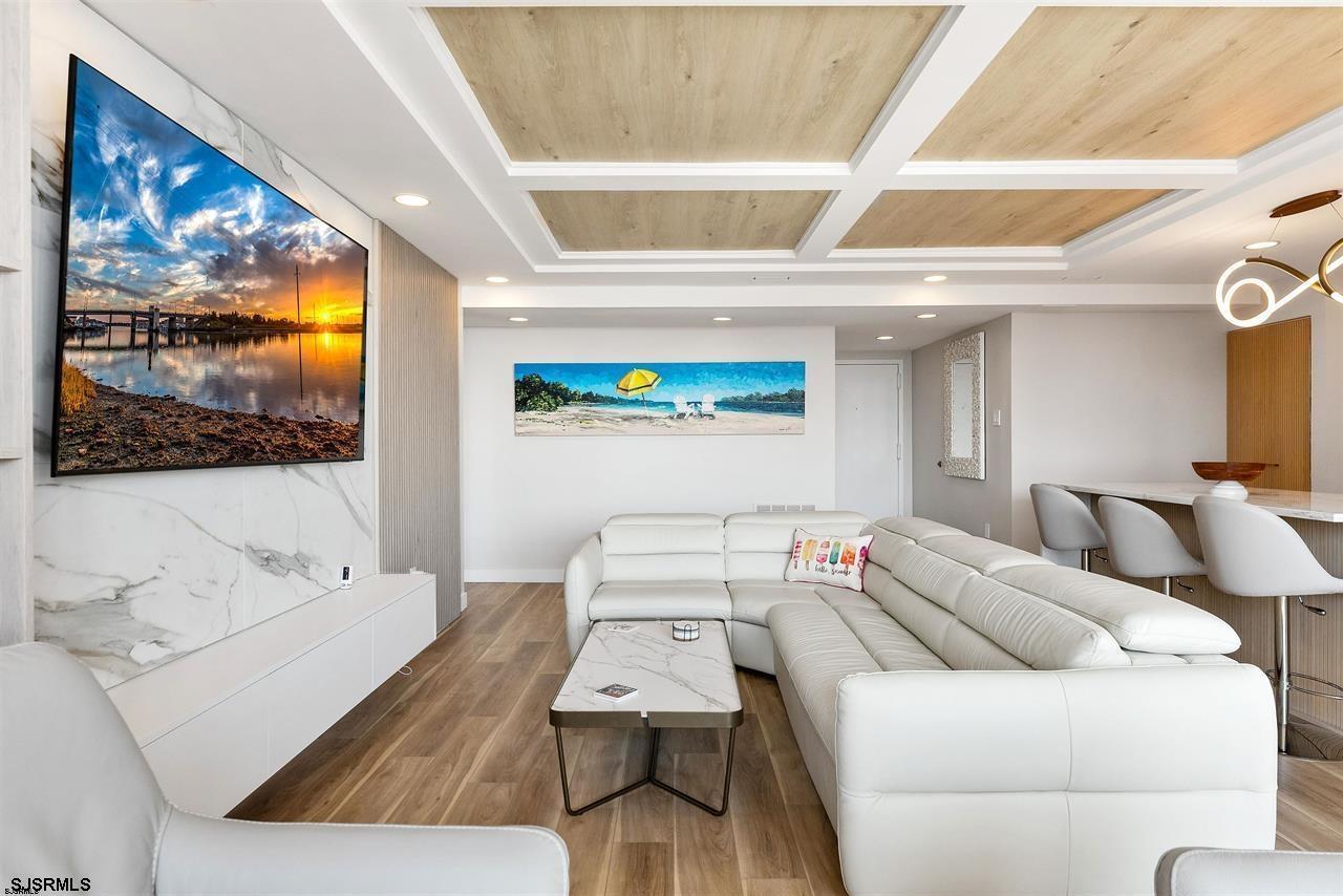 9100 Beach 304, Unit 304 Margate City, NJ 08402 - Photo 4 of 25 a living room with furniture and a flat screen tv