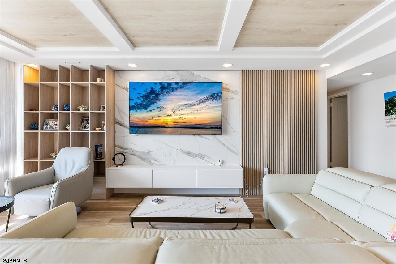 9100 Beach 304, Unit 304 Margate City, NJ 08402 - Photo 5 of 25 a living room with furniture and a flat screen tv