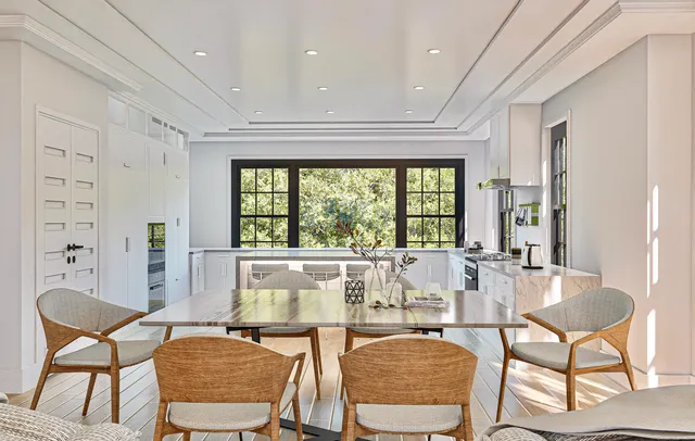 a dining room with furniture a chandelier and wooden floor