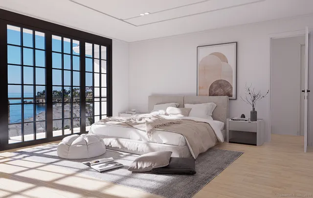 a bedroom with a bed and a large window