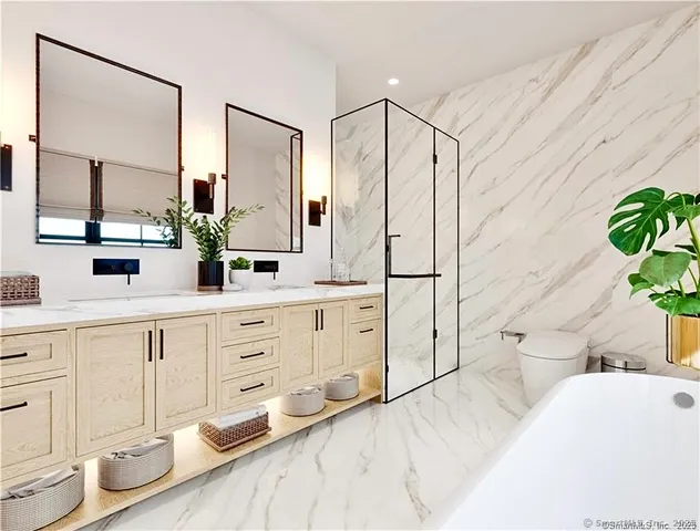 a spacious bathroom with double vanity sink a mirror a bathtub and shower