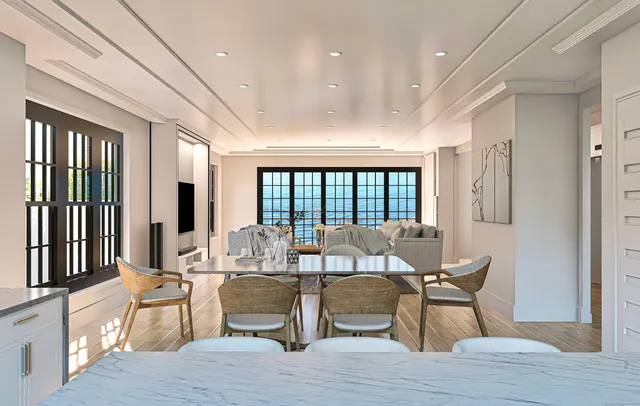 a living room with furniture and large windows