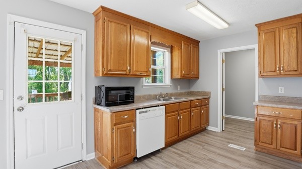 19 Ash Grove Road Fayetteville, TN 37334 - Photo 18 of 31 a kitchen with stainless steel appliances granite countertop a stove a sink and a microwave