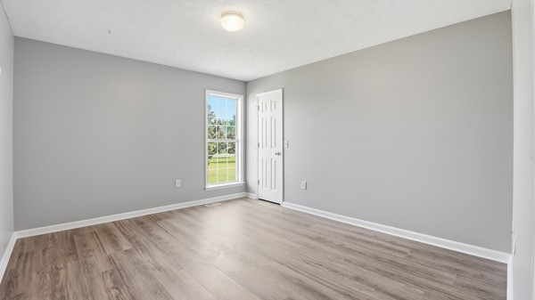 19 Ash Grove Road Fayetteville, TN 37334 - Photo 25 of 31 a view of an empty room with wooden floor and a window