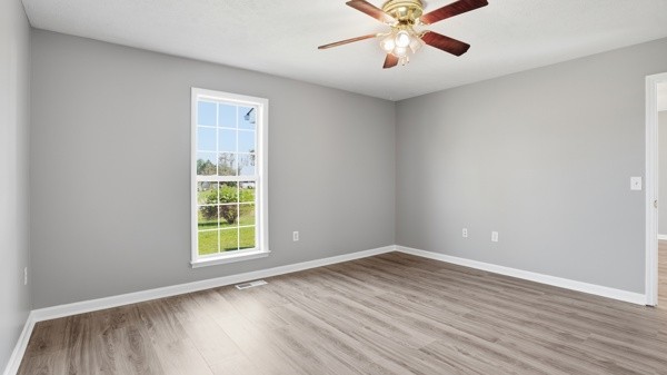 19 Ash Grove Road Fayetteville, TN 37334 - Photo 30 of 31 an empty room with wooden floor chandelier fan and windows