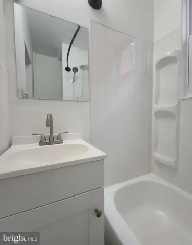 a bathroom with a sink and mirror