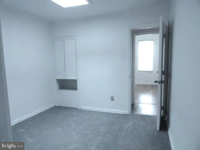 an empty room with a empty space and windows