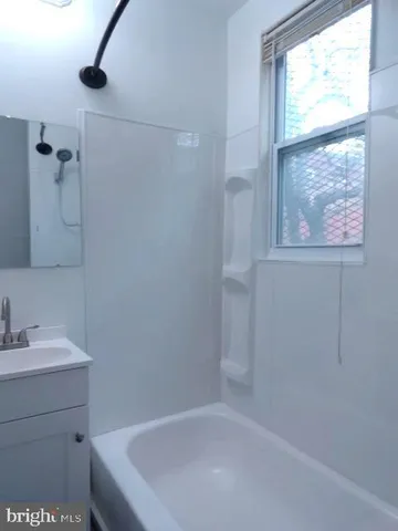 a bathroom with a bathtub and a sink