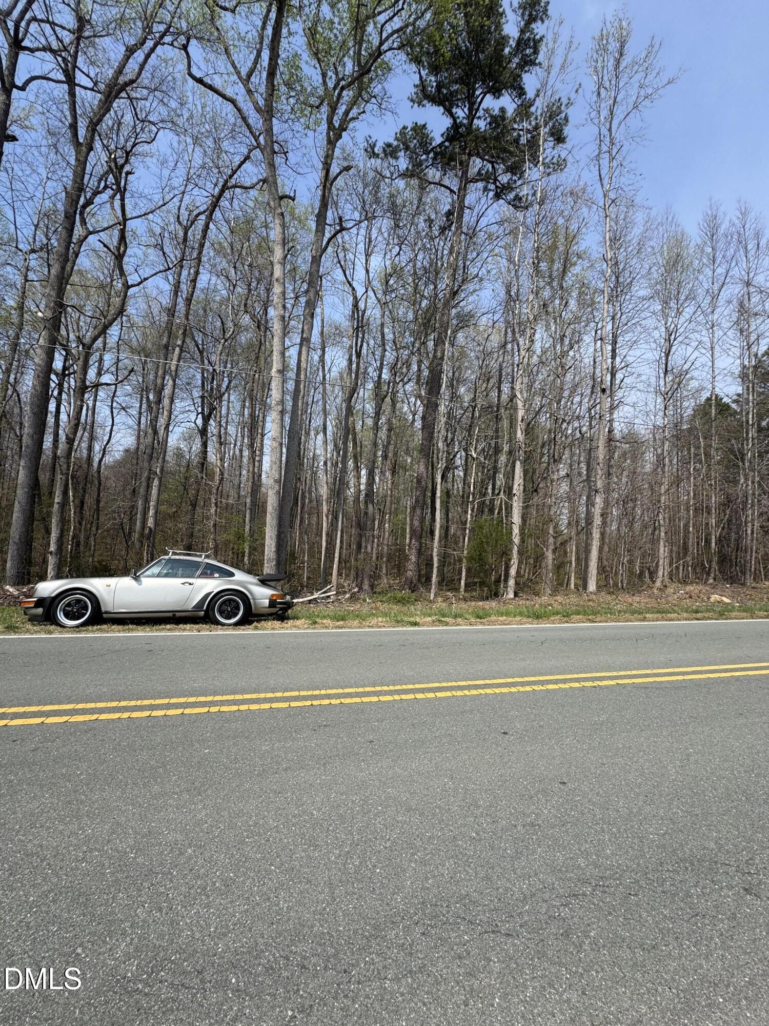 0 Hurdle Mills Road Hurdle Mills, NC 27541 - Photo 2 of 7 a view of a house with a yard and a large tree