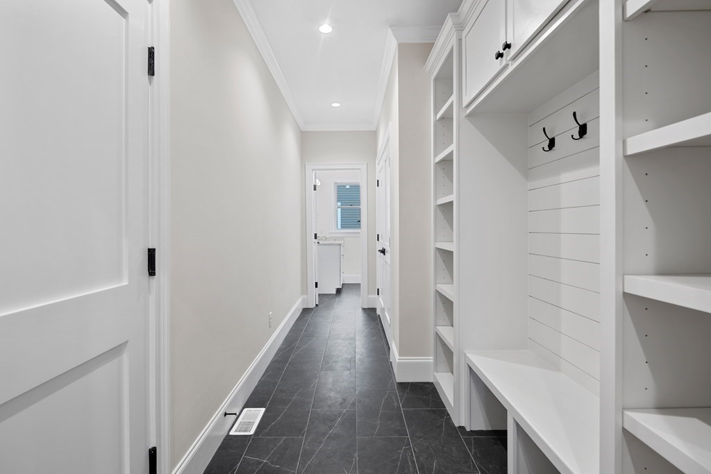 28 Hillside Avenue Needham, MA 02494 - Photo 14 of 32 a hallway with wooden floor and staircase