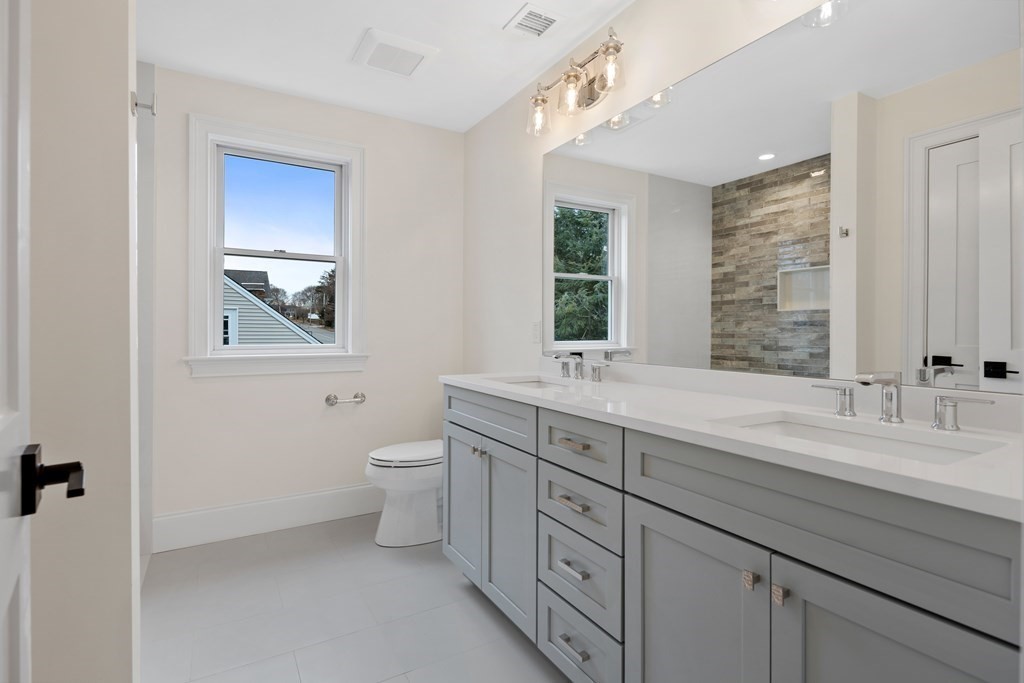 28 Hillside Avenue Needham, MA 02494 - Photo 18 of 32 a spacious bathroom with a double vanity sink a toilet and a mirror