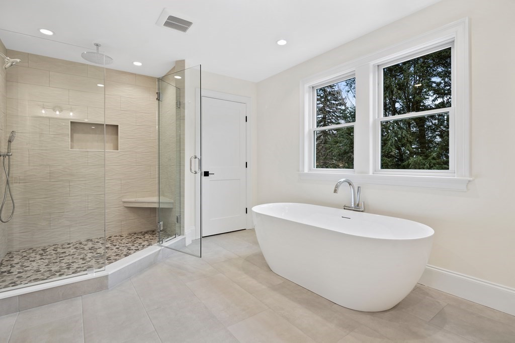 28 Hillside Avenue Needham, MA 02494 - Photo 19 of 32 a bathroom with a white tub shower and window