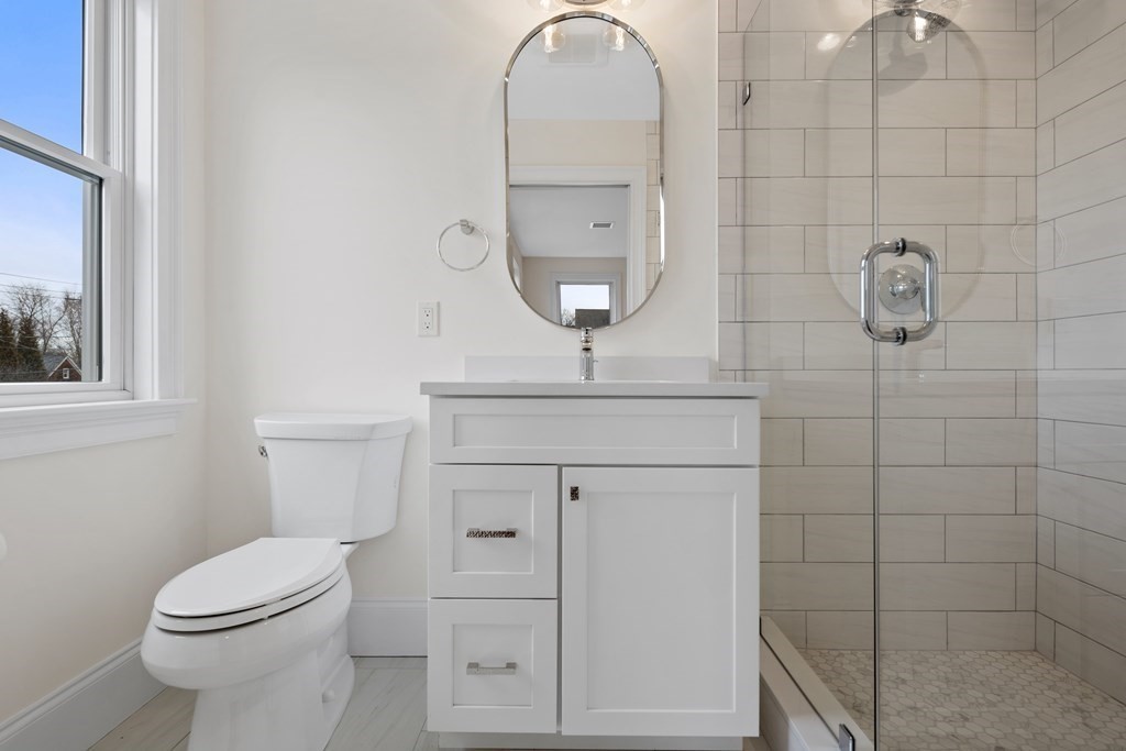28 Hillside Avenue Needham, MA 02494 - Photo 21 of 32 a bathroom with a toilet a sink and mirror