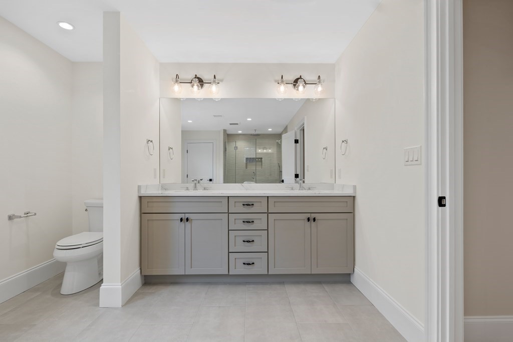 28 Hillside Avenue Needham, MA 02494 - Photo 22 of 32 a spacious bathroom with a double vanity sink a toilet and a mirror