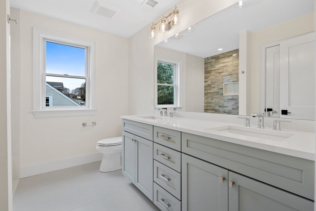 28 Hillside Avenue Needham, MA 02494 - Photo 24 of 32 a bathroom with a double vanity sink a toilet and a mirror