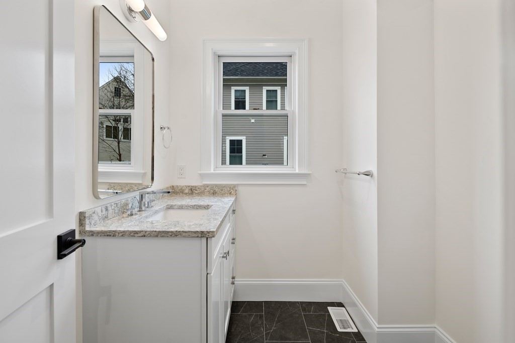 28 Hillside Avenue Needham, MA 02494 - Photo 26 of 32 a bathroom with a sink and a mirror
