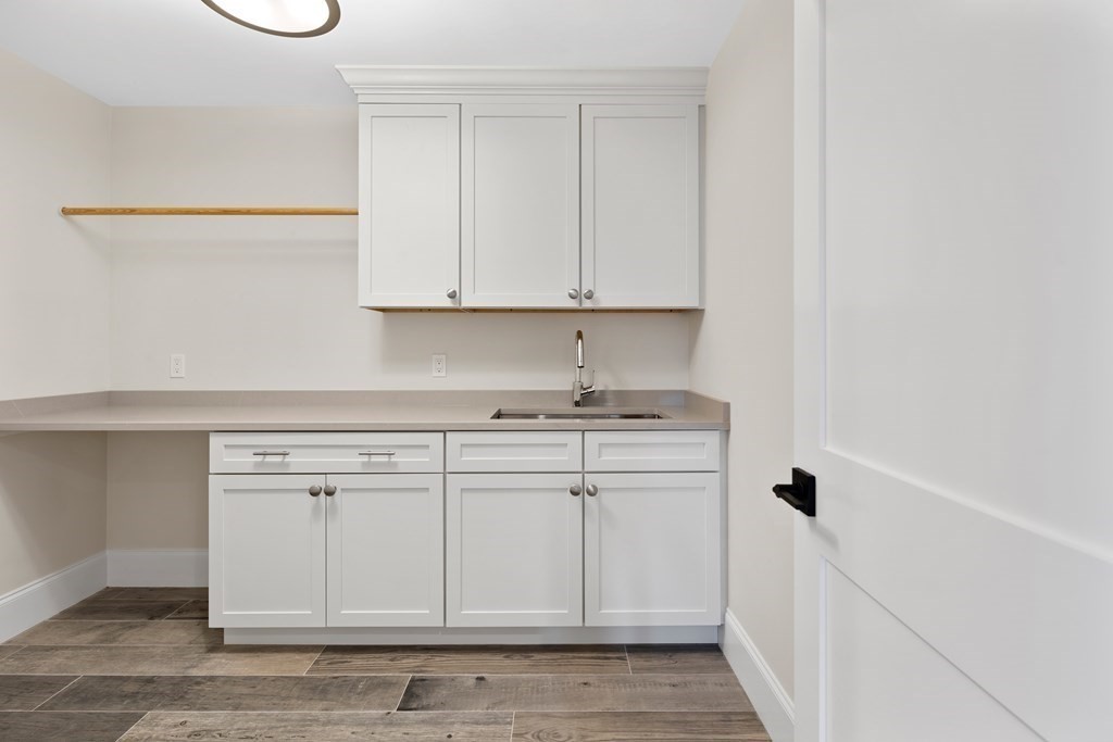 28 Hillside Avenue Needham, MA 02494 - Photo 28 of 32 a kitchen with granite countertop white cabinets and a stove