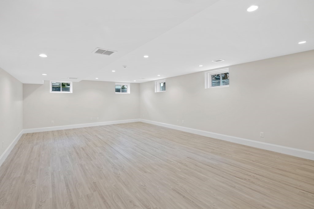 28 Hillside Avenue Needham, MA 02494 - Photo 31 of 32 a view of an empty room with wooden floor and a window