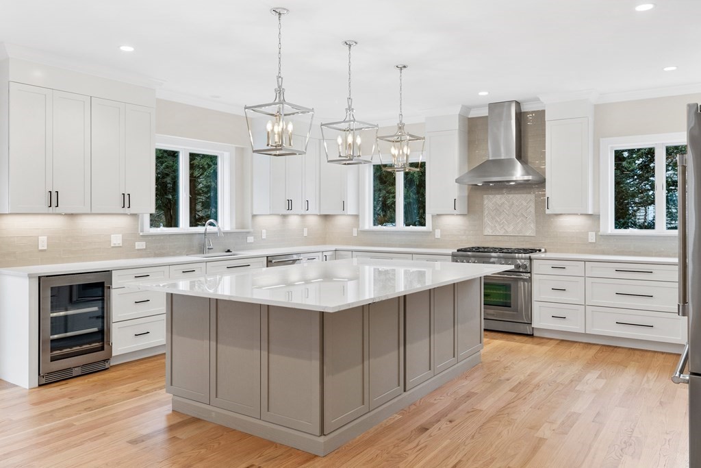 28 Hillside Avenue Needham, MA 02494 - Photo 4 of 32 a kitchen with stainless steel appliances granite countertop a sink stove and refrigerator