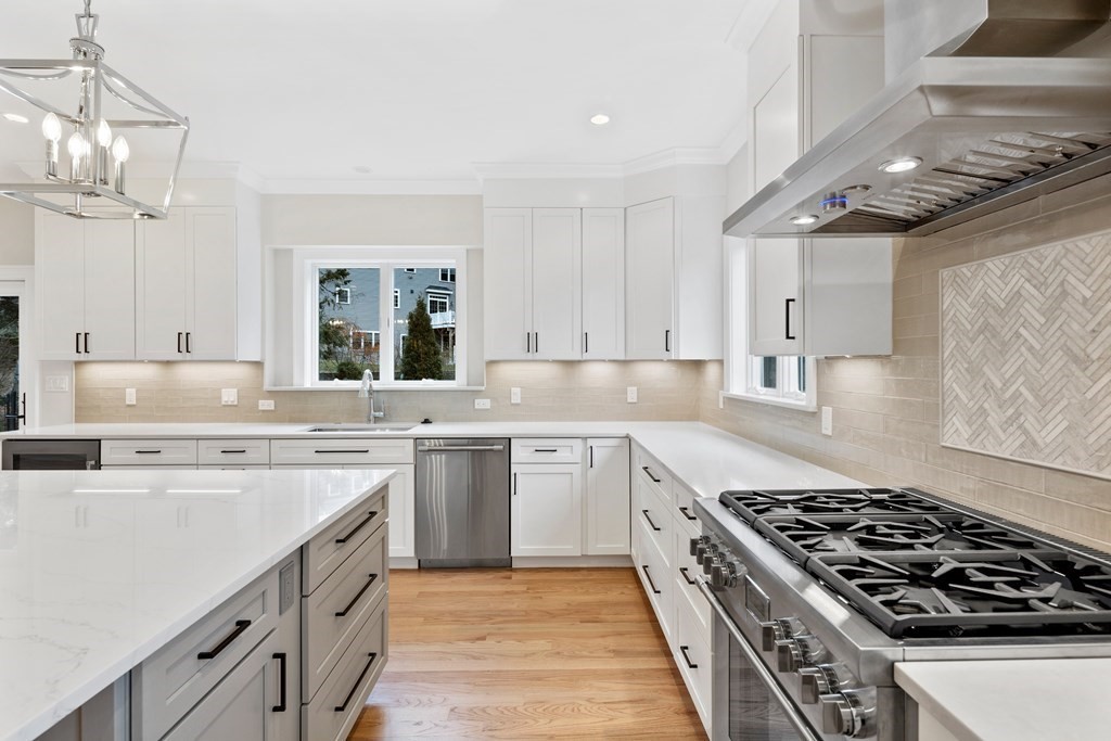 28 Hillside Avenue Needham, MA 02494 - Photo 7 of 32 a kitchen with a stove sink and cabinets