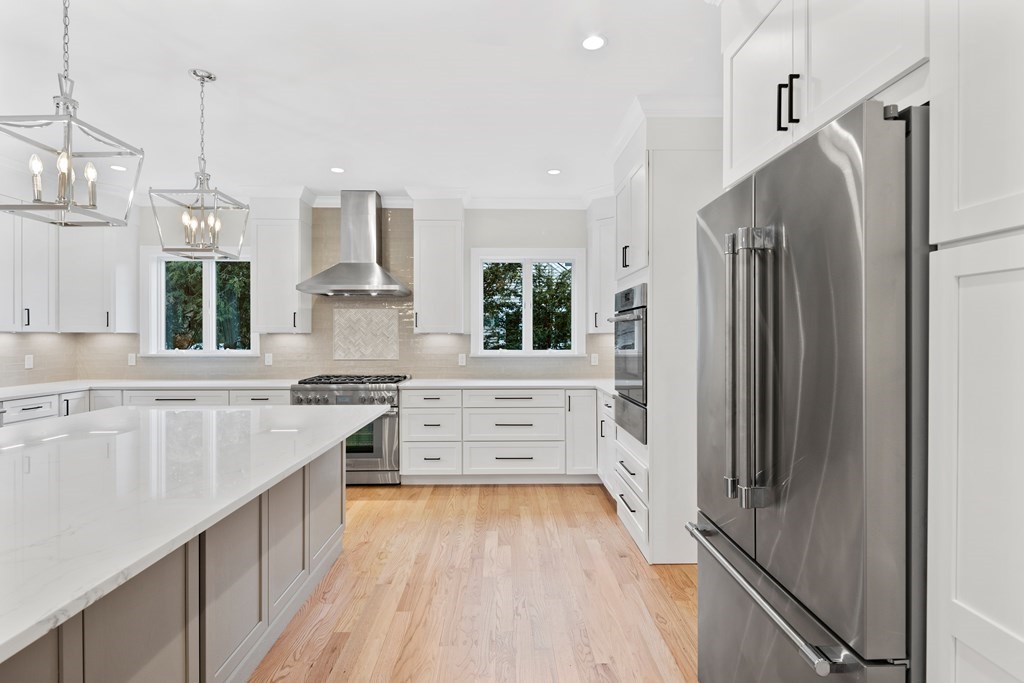 28 Hillside Avenue Needham, MA 02494 - Photo 8 of 32 a kitchen with stainless steel appliances a refrigerator sink and stove