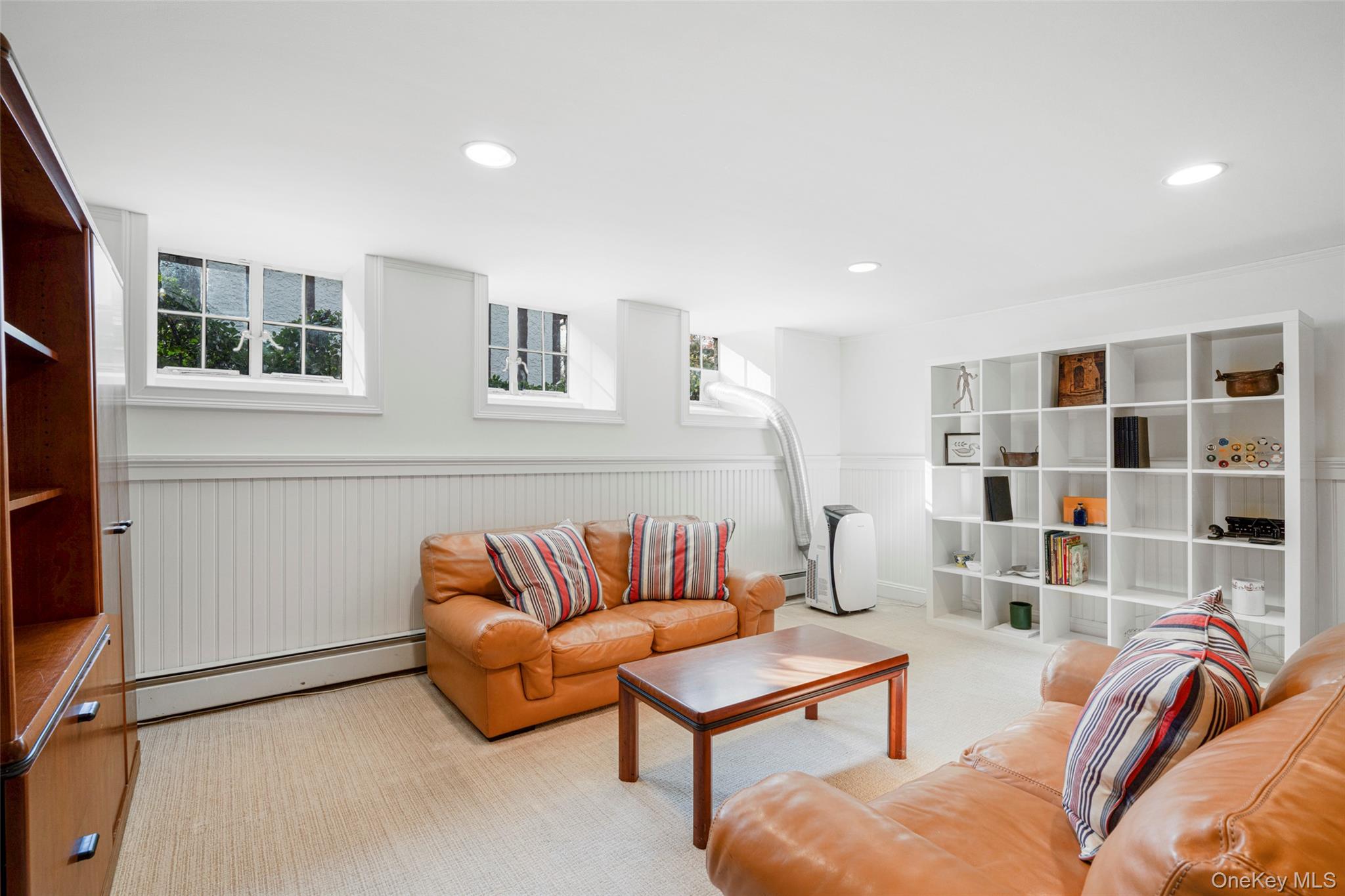290 Overlook Road New Rochelle, NY 10804 - Photo 23 of 38 a living room with furniture and a book shelf