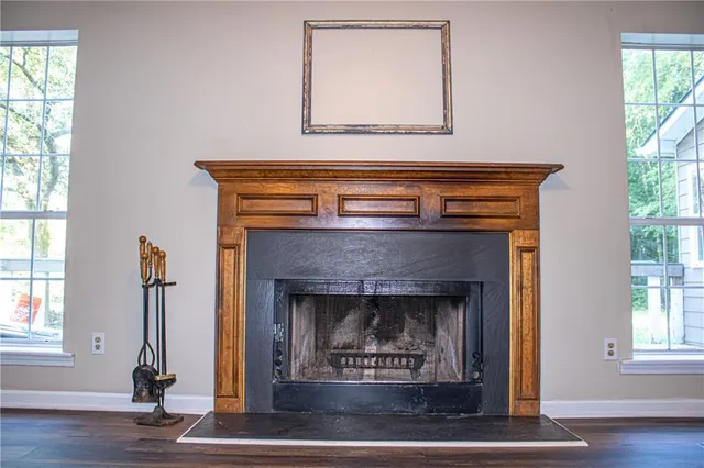 a living room with a fireplace and windows