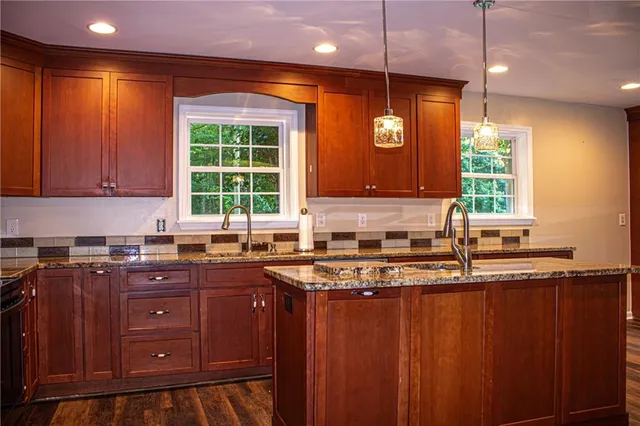 a kitchen with wooden cabinets and a window