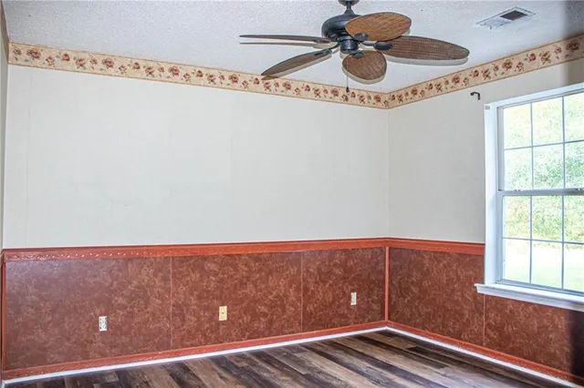 a view of room with window and wooden floor