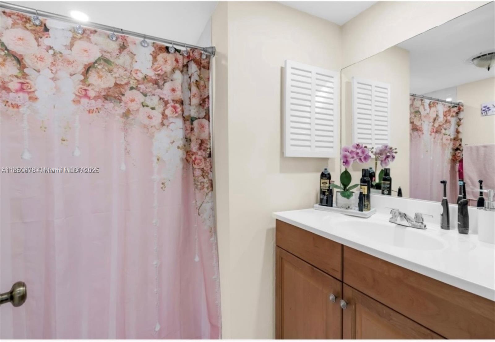 8401 Southwest 107th Avenue, Unit 311E Miami, FL 33173 - Photo 7 of 9 a bathroom with a sink a vanity and a mirror