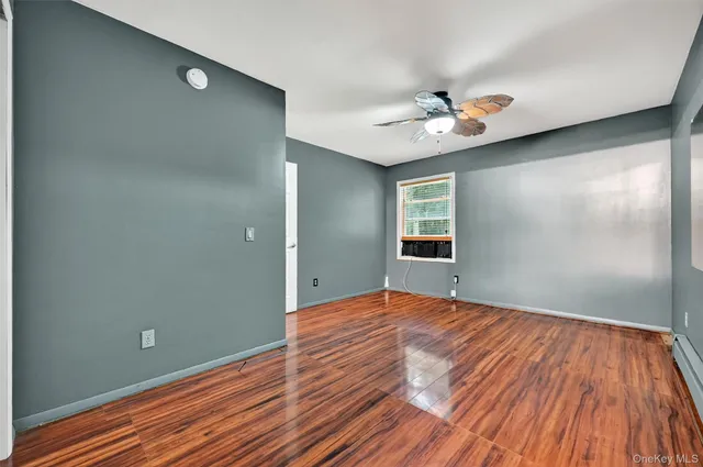 wooden floor in an empty room with a window