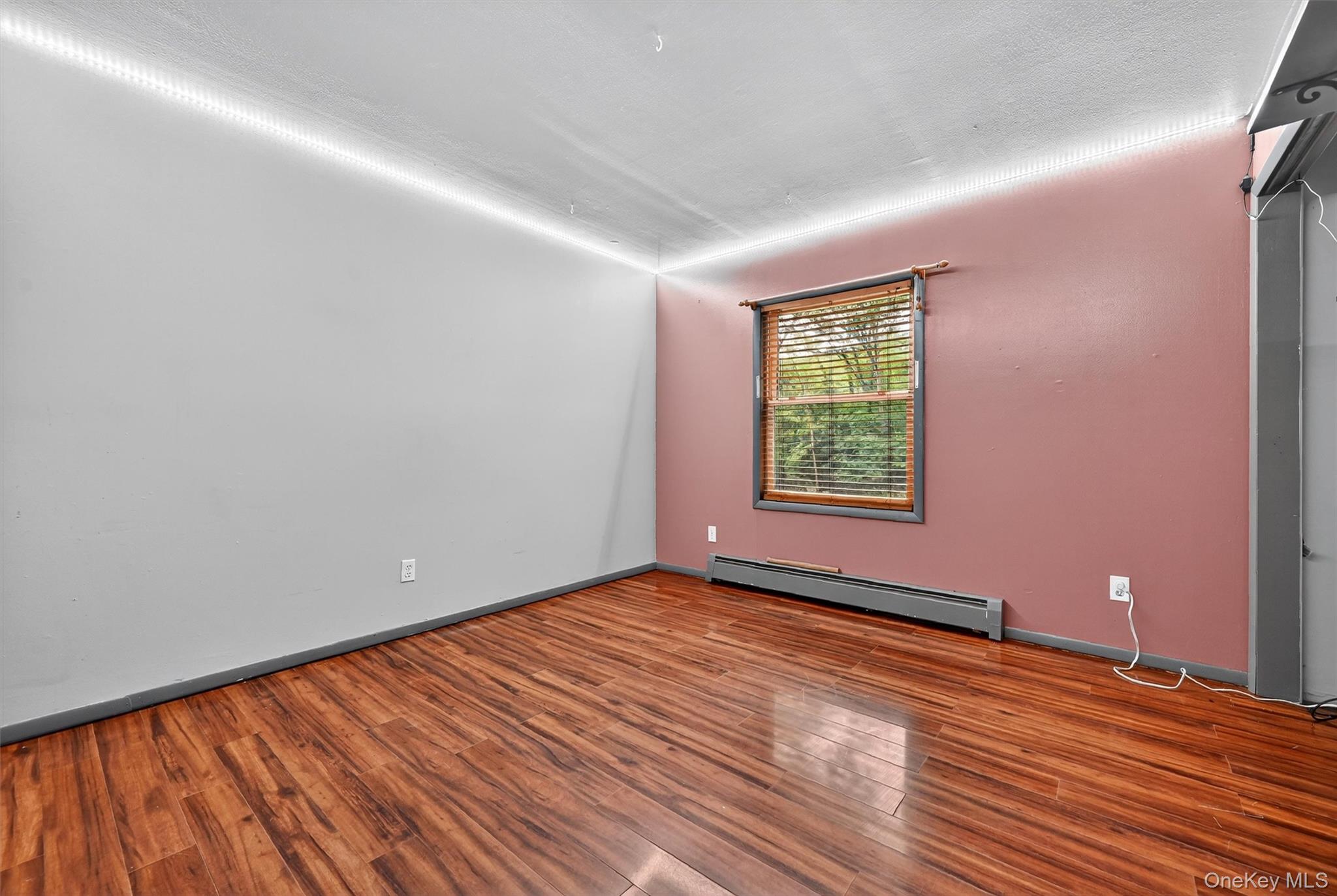 58 Shinhollow Road Port Jervis, NY 12771 - Photo 14 of 38 a view of an empty room with wooden floor and a window