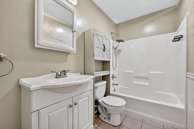a bathroom with a sink toilet vanity and shower