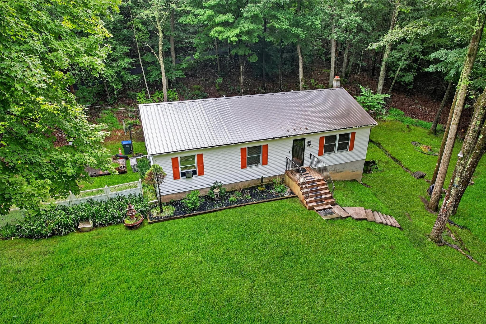 58 Shinhollow Road Port Jervis, NY 12771 - Photo 33 of 38 a aerial view of a house with a yard table and chairs