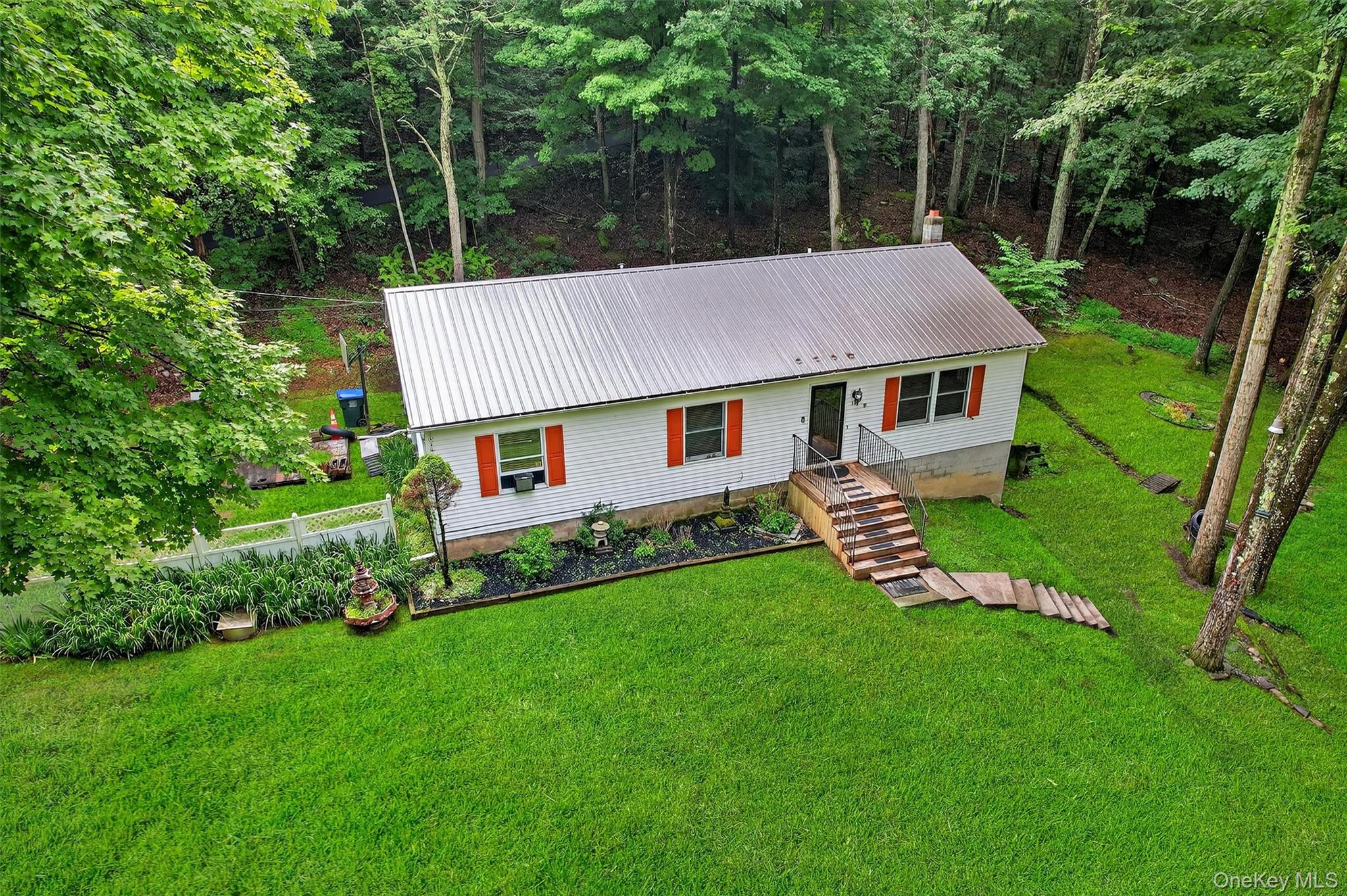 58 Shinhollow Road Port Jervis, NY 12771 - Photo 33 of 38 a aerial view of a house with a yard table and chairs