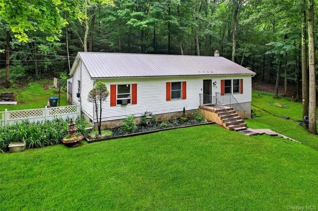 a front view of a house with a garden