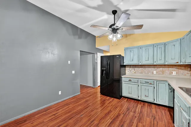 a kitchen with stainless steel appliances granite countertop a refrigerator a sink and dishwasher