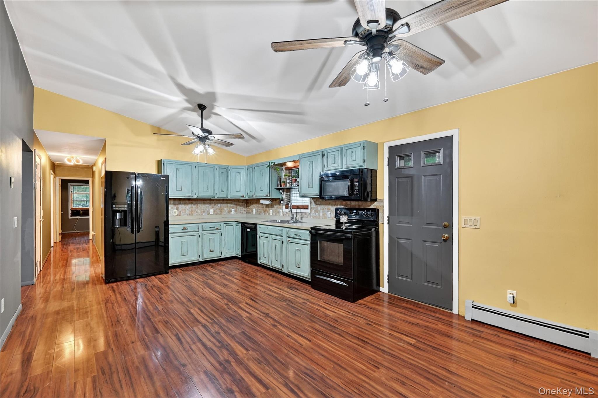 58 Shinhollow Road Port Jervis, NY 12771 - Photo 7 of 38 a large kitchen with a wooden floor and stainless steel appliances