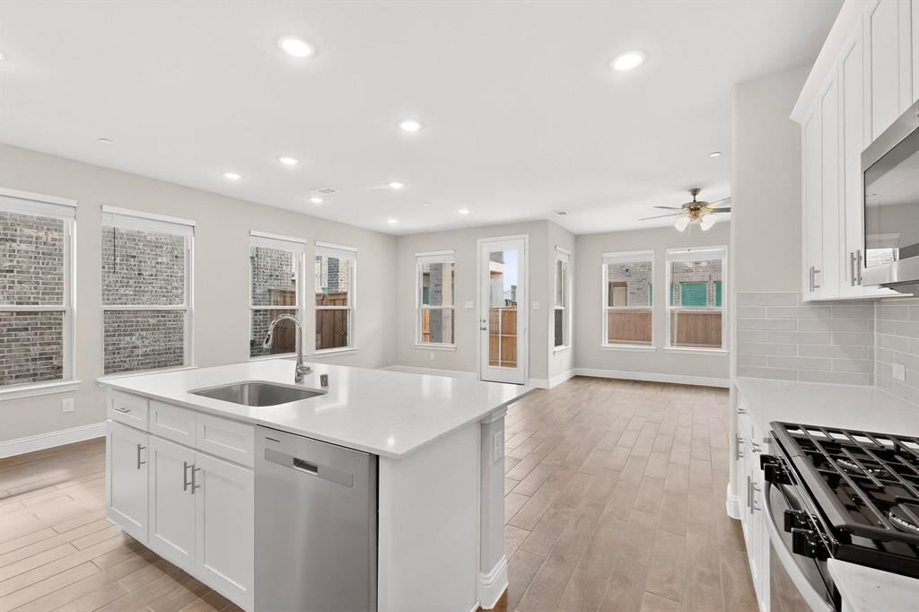 900 Heart Reef Road Plano, TX 75075 - Photo 12 of 40 a view of kitchen with sink and wooden floor