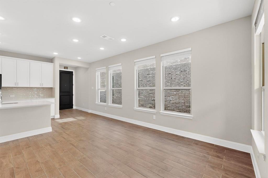 900 Heart Reef Road Plano, TX 75075 - Photo 14 of 40 a view of an empty room with wooden floor and a window