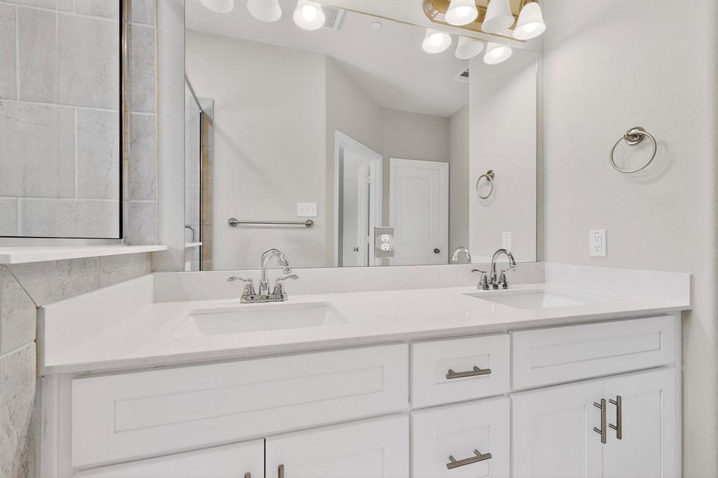 900 Heart Reef Road Plano, TX 75075 - Photo 21 of 40 a bathroom with a sink vanity and a mirror