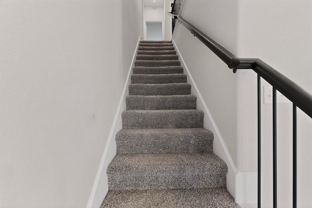 900 Heart Reef Road Plano, TX 75075 - Photo 6 of 40 a view of staircase with wooden floor and white walls